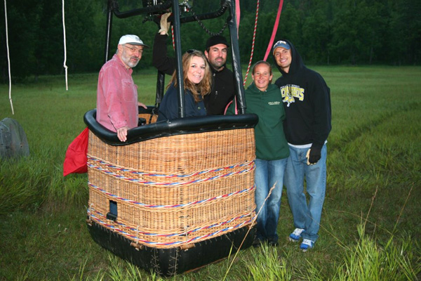 Balloon pilots Damien Mahony and Keely Wade with passenger Jay Davis prepare to launch from the Stratobowl.